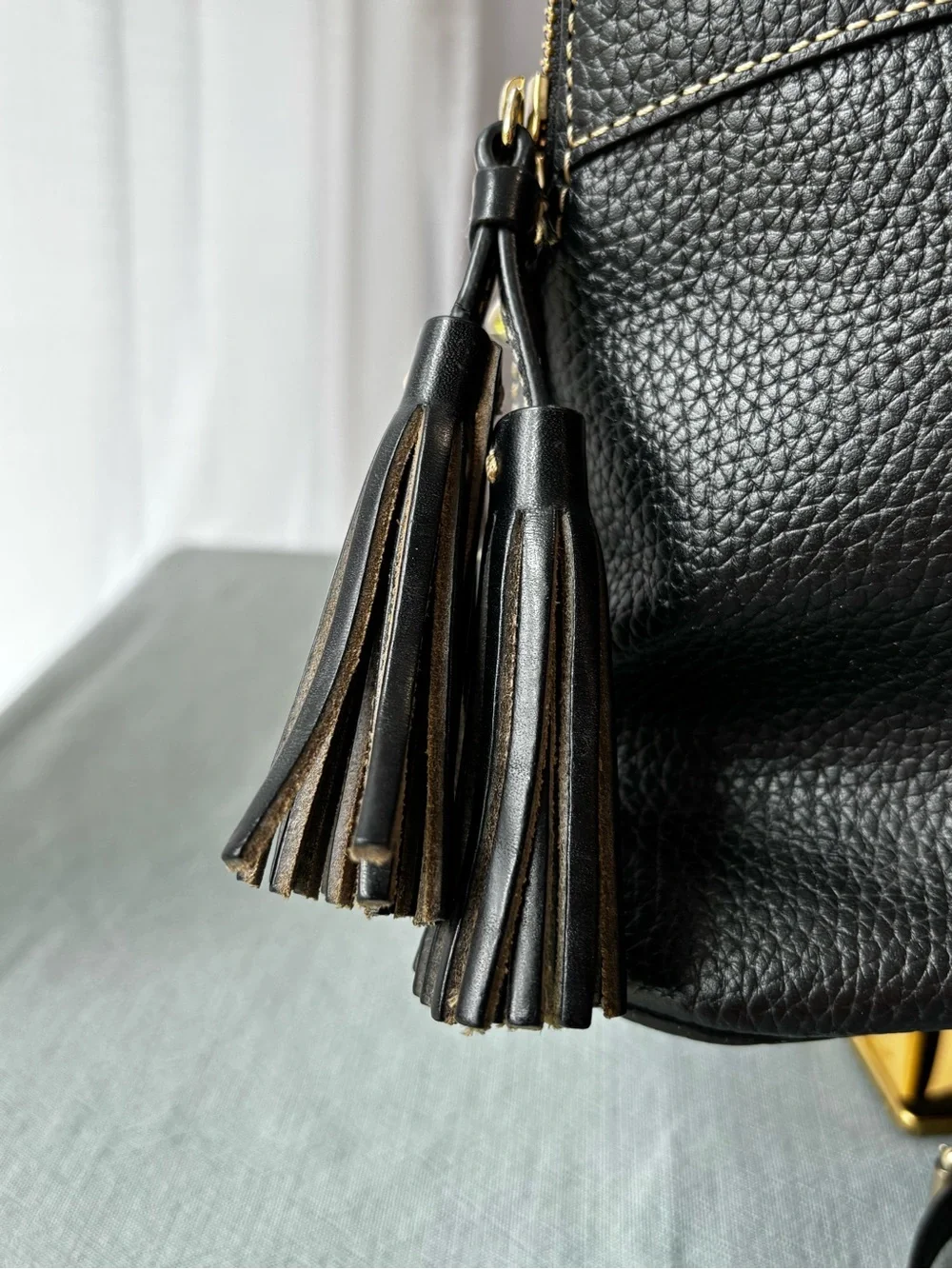 Dooney & Bourke Black Leather Satchel with Gold Hardware and Tassel